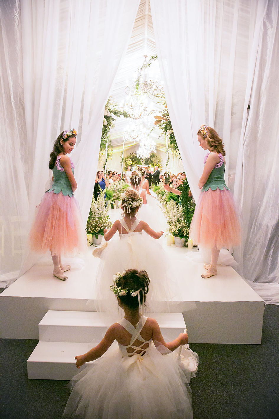 The flower girls walk down the aisle at Michael and Neda's wedding at Four Seasons Westlake Village