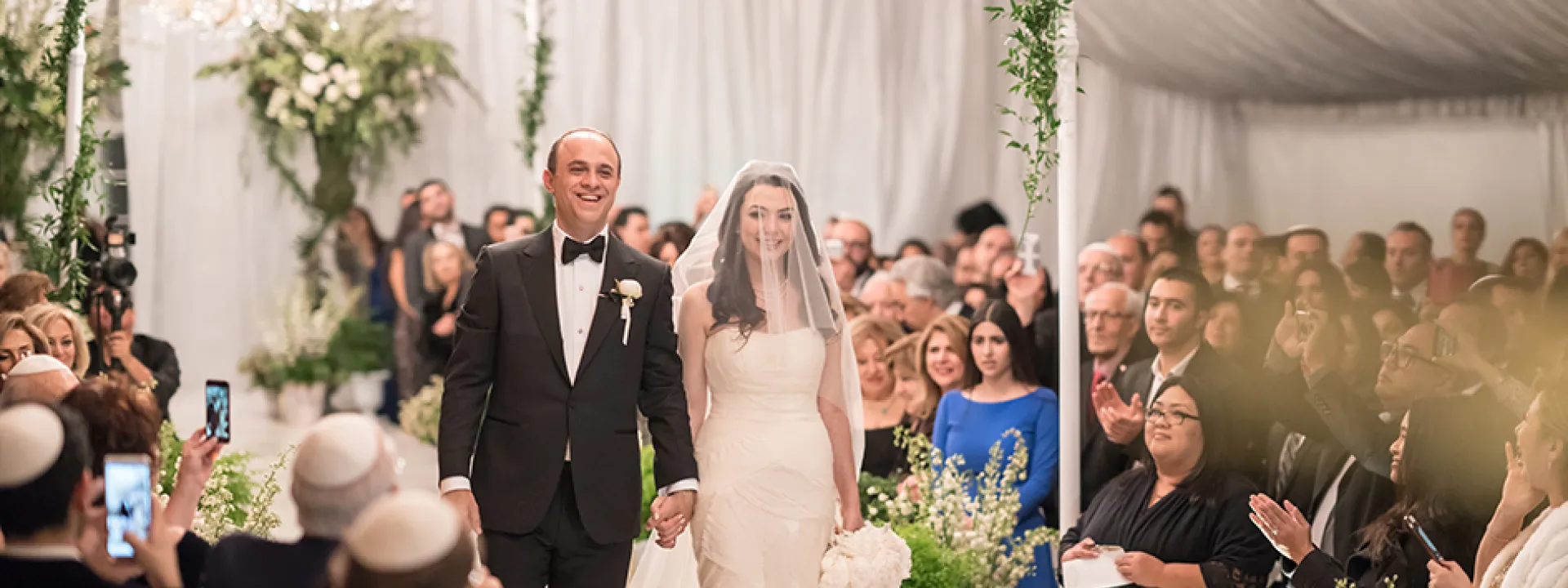 Michael and Neda walk down the aisle at their wedding at Four Seasons Westlake Village wedding.